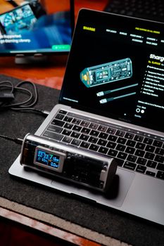 A stylish tech setup featuring a laptop and a digital monitor for enhanced productivity.