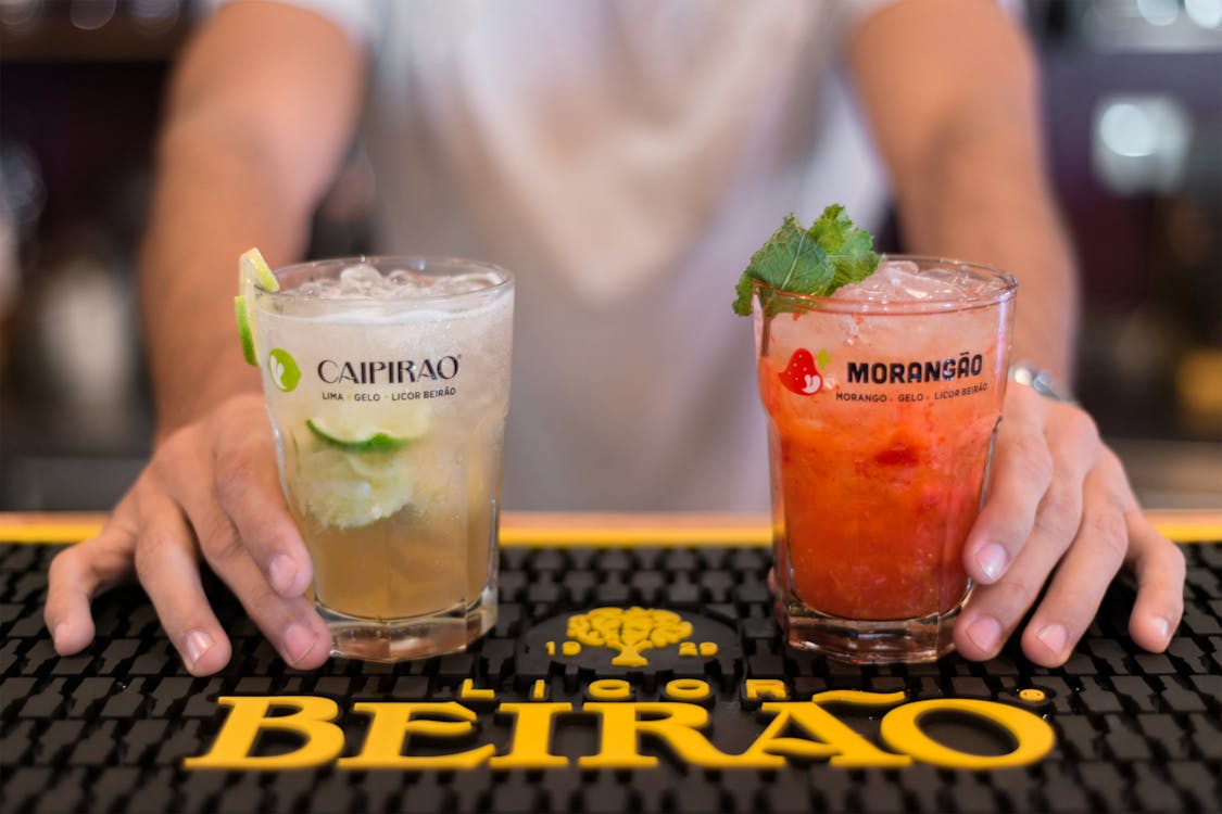 Free Bartender Serving Two Flavored Cocktails Stock Photo