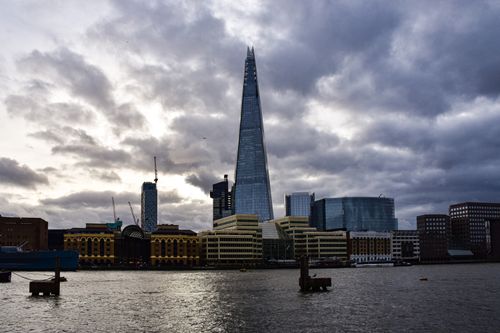Free Dramatic view of The Shard and the London skyline under moody clouds. Stock Photo