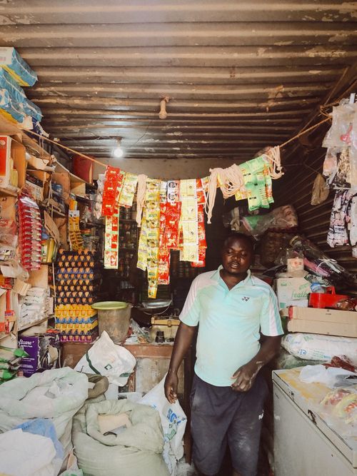 Free A shopkeeper inside a small local store filled with various goods. Stock Photo