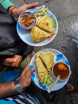 Delicious Indian flatbreads with curry served on the streets of Kolkata, vibrant and appetizing.