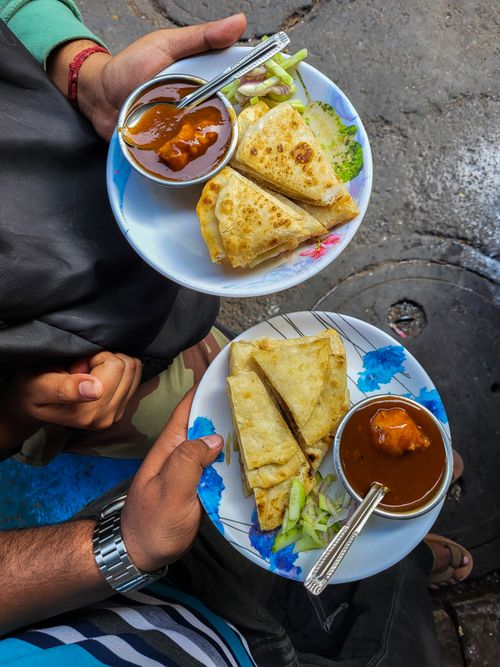 Free Delicious Indian flatbreads with curry served on the streets of Kolkata, vibrant and appetizing. Stock Photo