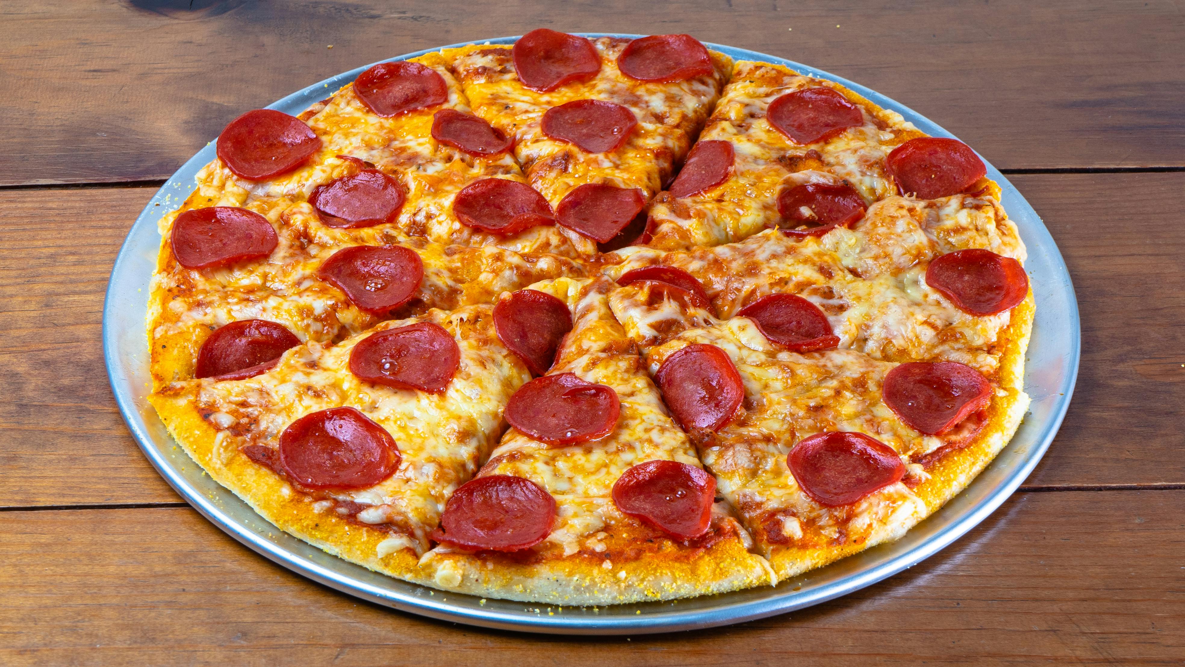Crisp and cheesy pepperoni pizza served on a rustic wooden table.