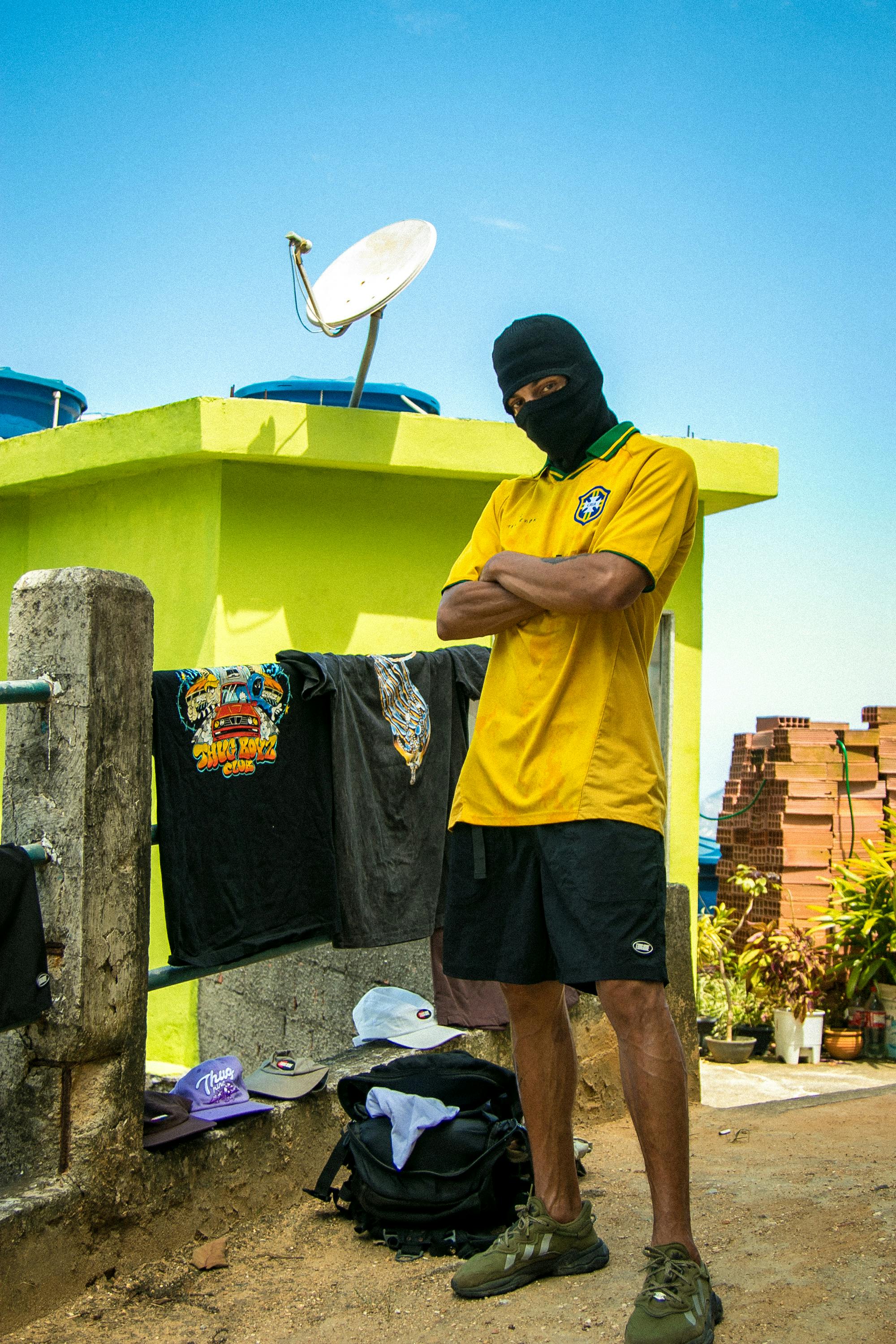 Masked Individual in Urban Rooftop Setting · Free Stock Photo