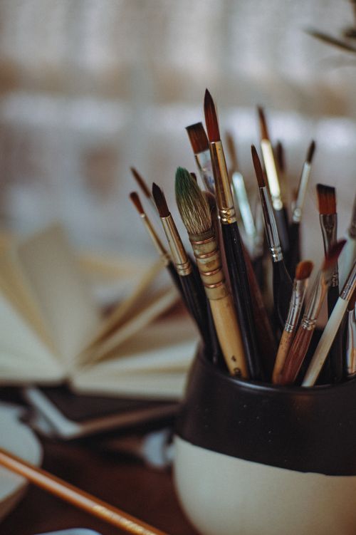Free A variety of paintbrushes in a jar, representing creativity and artistic expression. Stock Photo