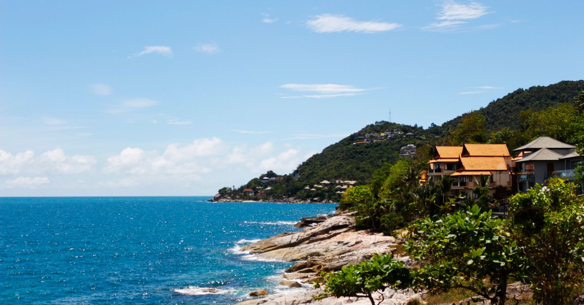 Explore the stunning coastal view of Koh Samui with lush greenery and bright blue sea.
