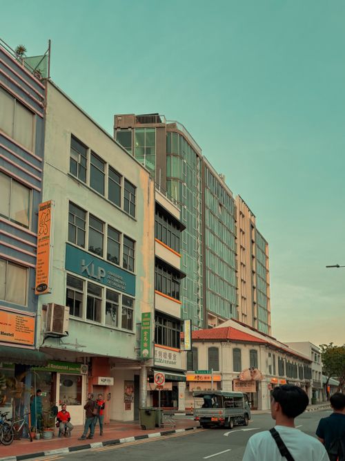 Free Vibrant street in Singapore showcasing colorful architecture and active pedestrians. Stock Photo