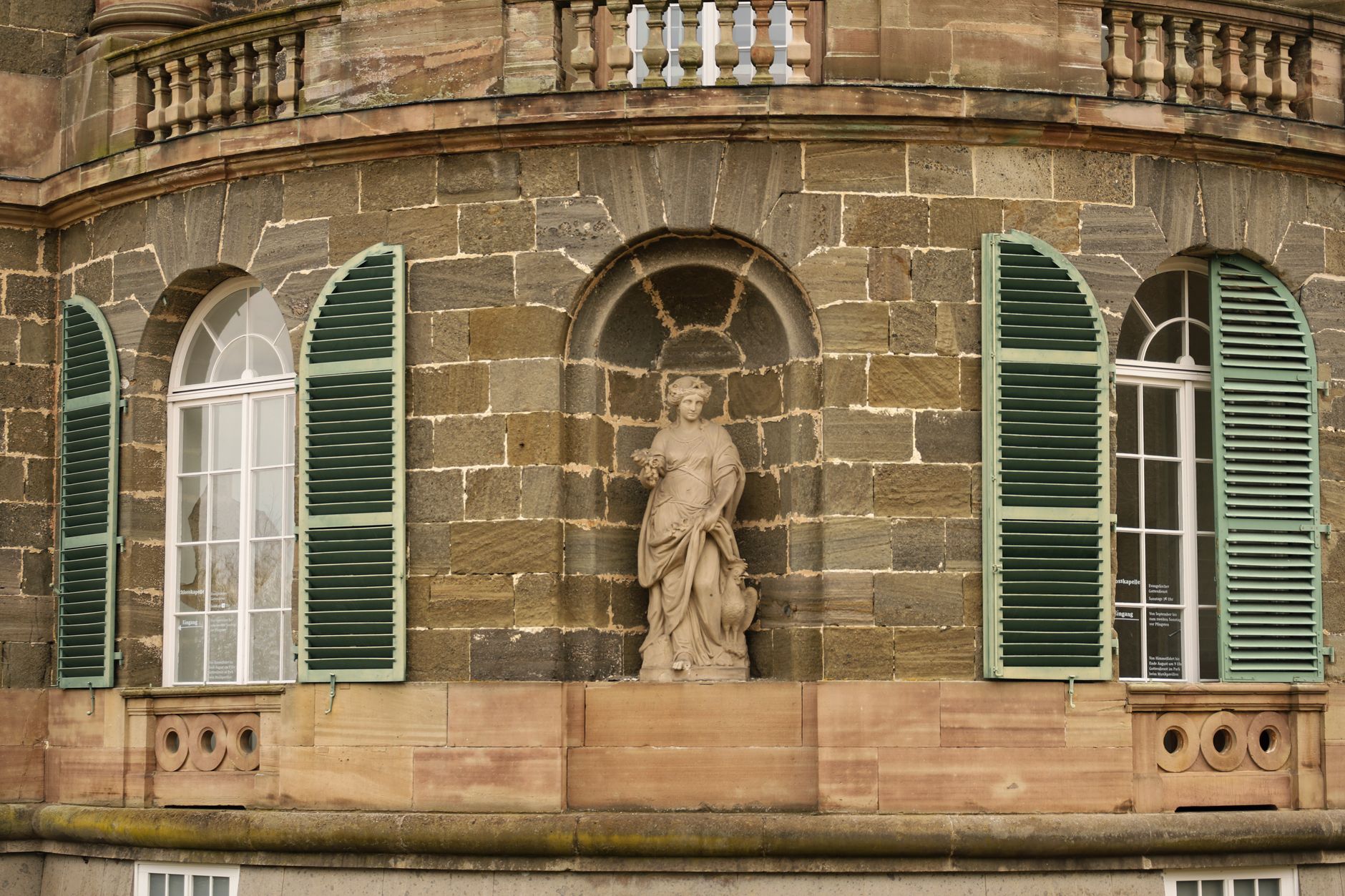 Intricate stone facade with statue at Schloss Wilhelmshöhe, Kassel, Germany.