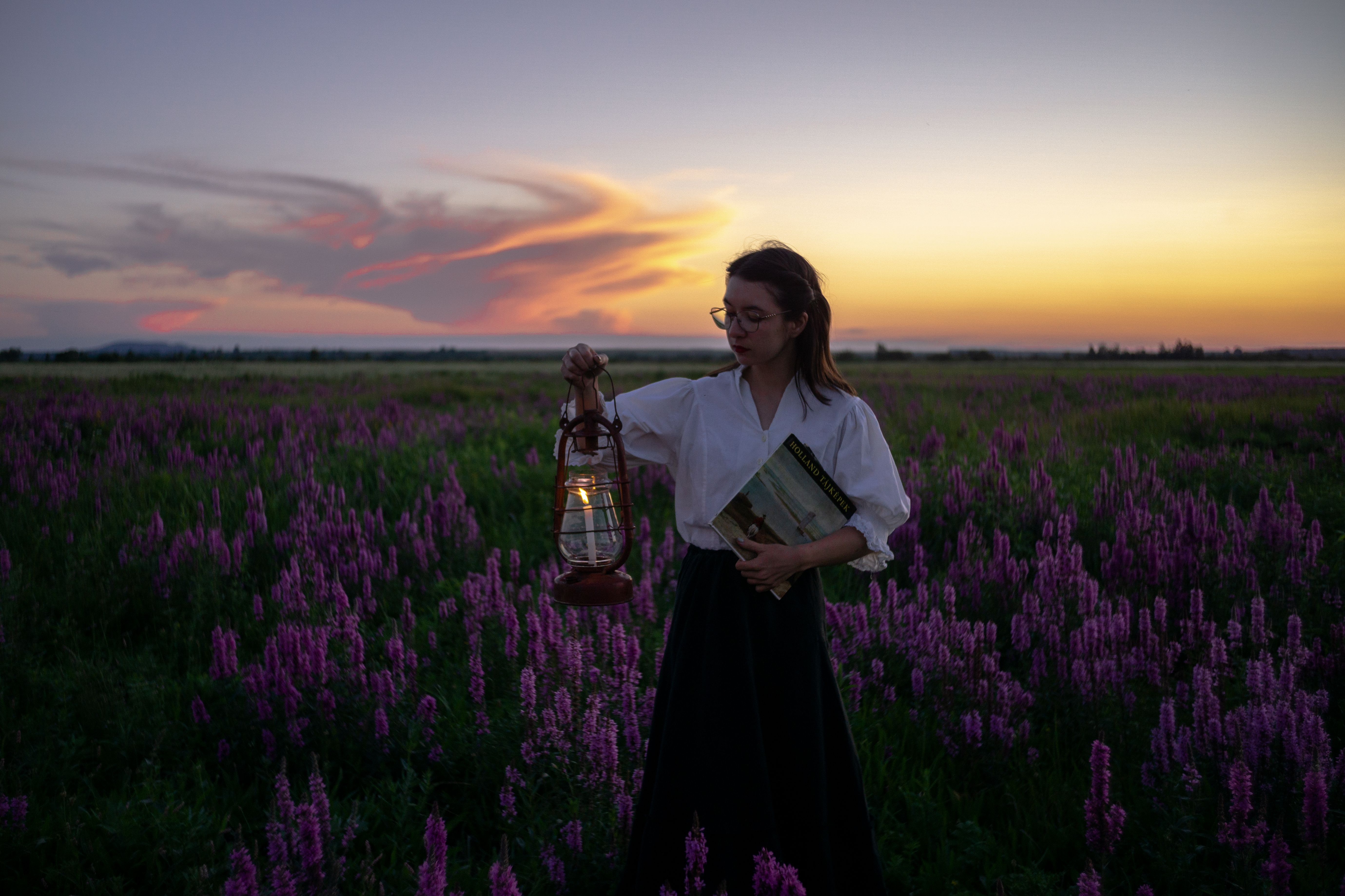 Woman Holding Lantern in Lavender Field at Sunset · Free Stock Photo