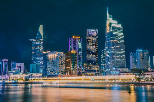 Stunning long exposure of Ho Chi Minh City's skyline at night, reflecting vibrant city lights.