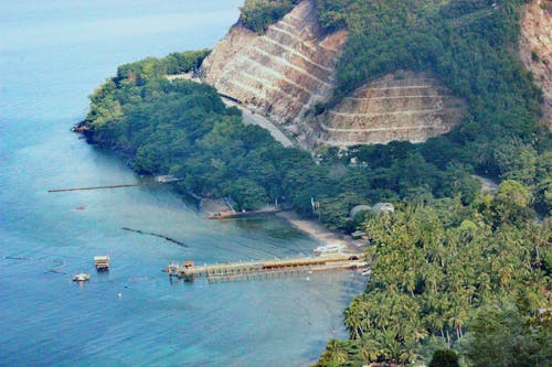 Free Aerial view of a lush coastal landscape in Banaybanay, Philippines. Stock Photo