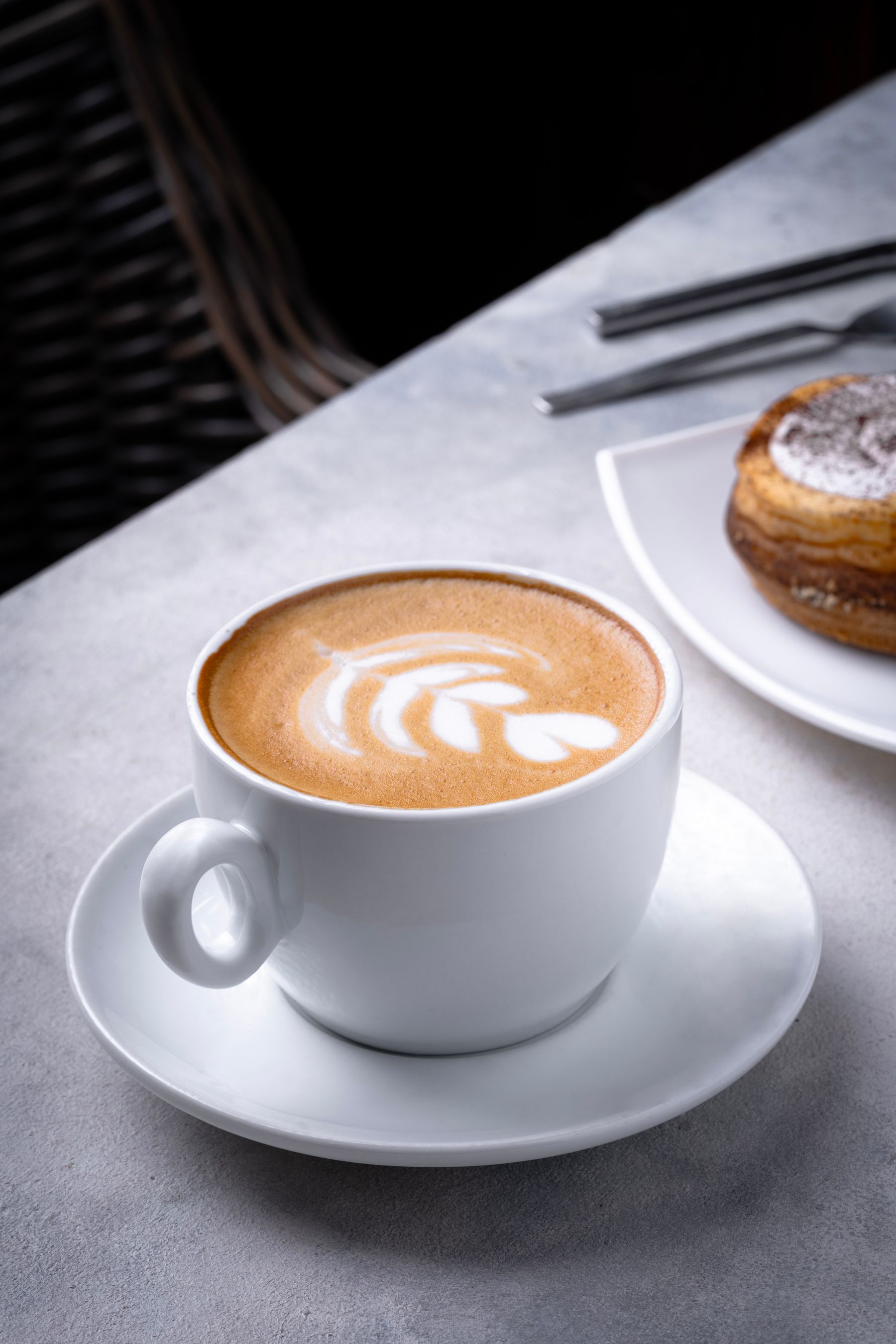 Latte and pastry at a cafe