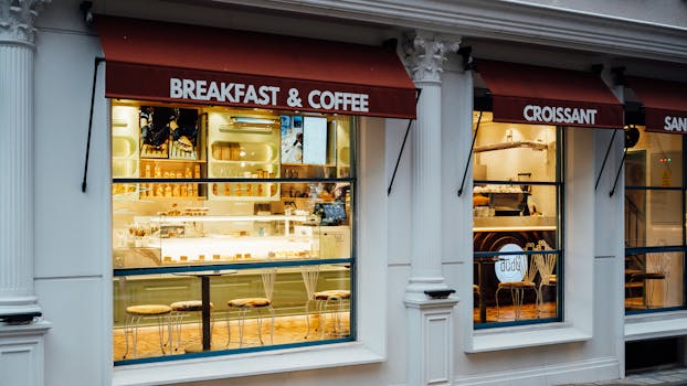 A cozy café with inviting window displays offering breakfast and coffee. Perfect for a morning treat.