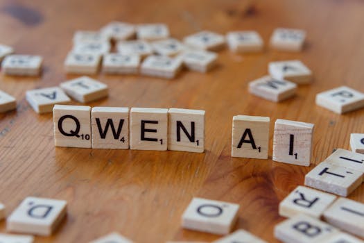 Tessere simili allo Scrabble disposte a formare la parola "Qwen AI" su una superficie di legno, raffiguranti concetti tecnologici.
