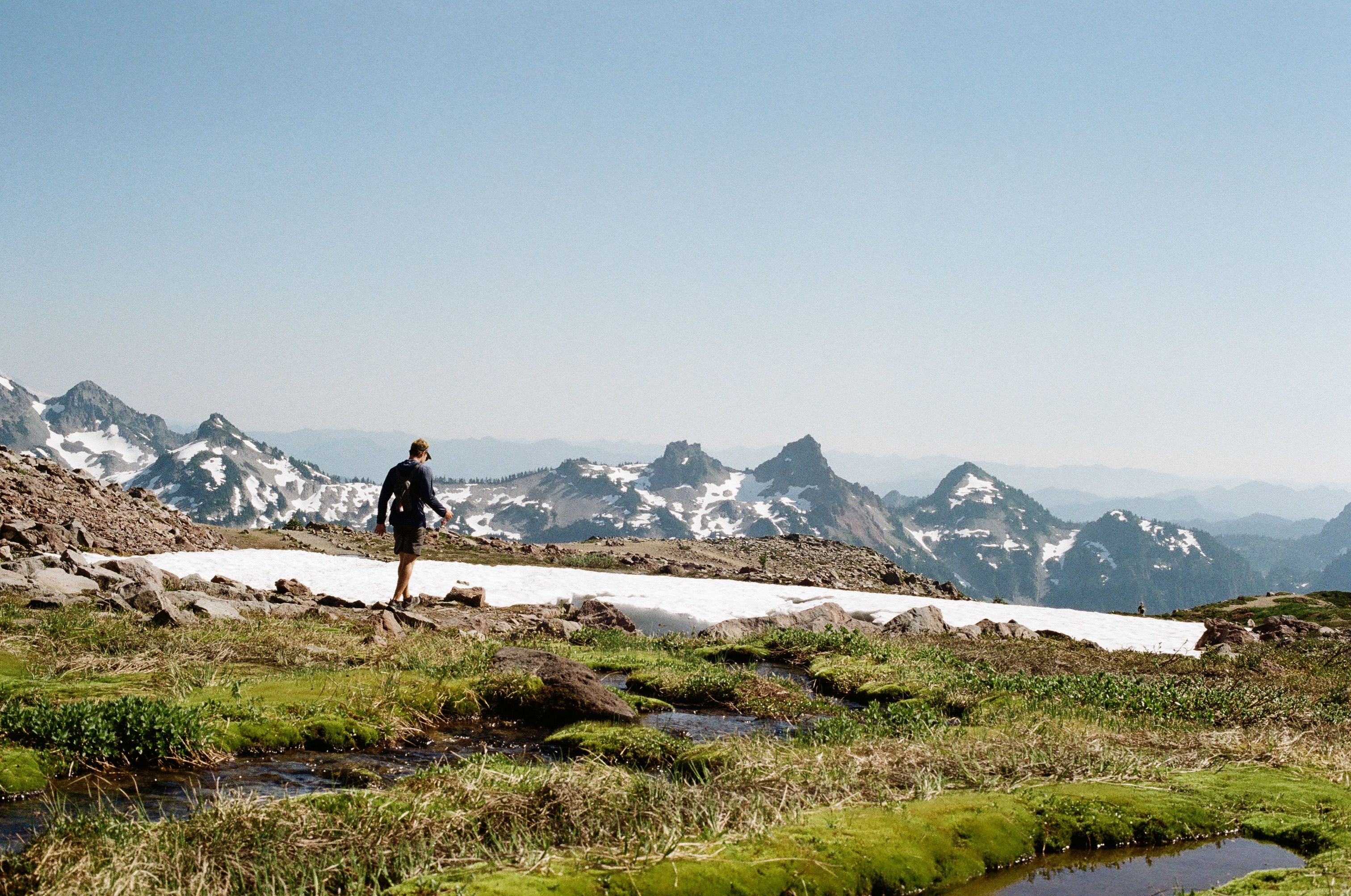 Hiker Exploring Snowy Mountain Landscape · Free Stock Photo