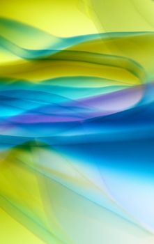 Abstract art with vibrant waves in blue, green, and yellow hues creating a fluid, dynamic pattern.
