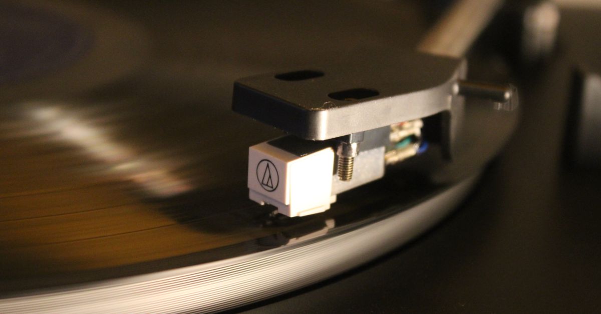 Close-up of a turntable needle dropping onto a vinyl record