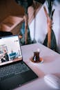Cozy Workspace with Laptop and Tea on Table