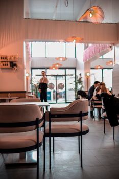 Inviting modern cafe interior with stylish decor and warm lighting ambiance.