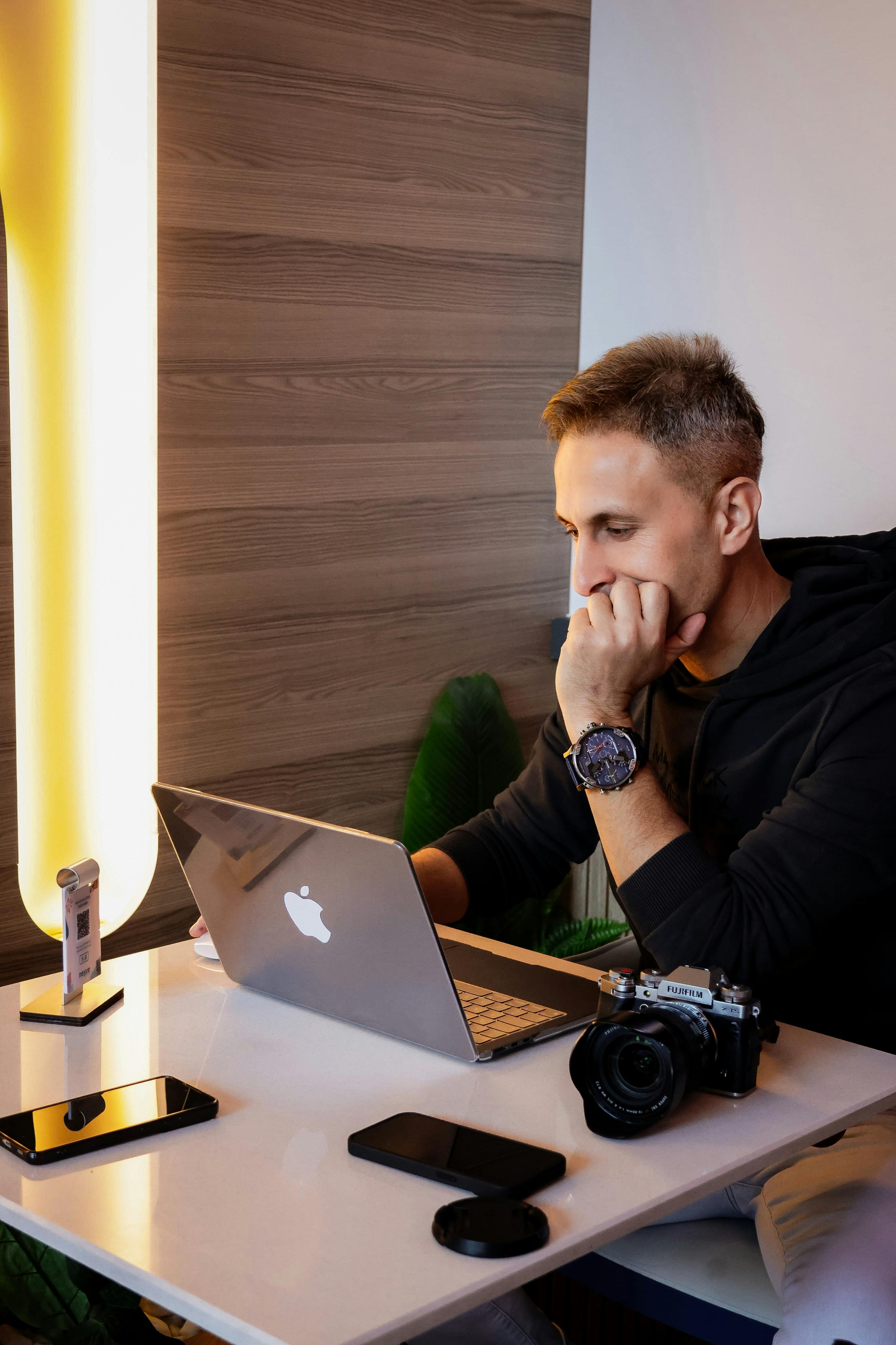 focused man working on laptop in home office