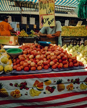 Colorful display of fresh fruits at a bustling Brazilian market stall.