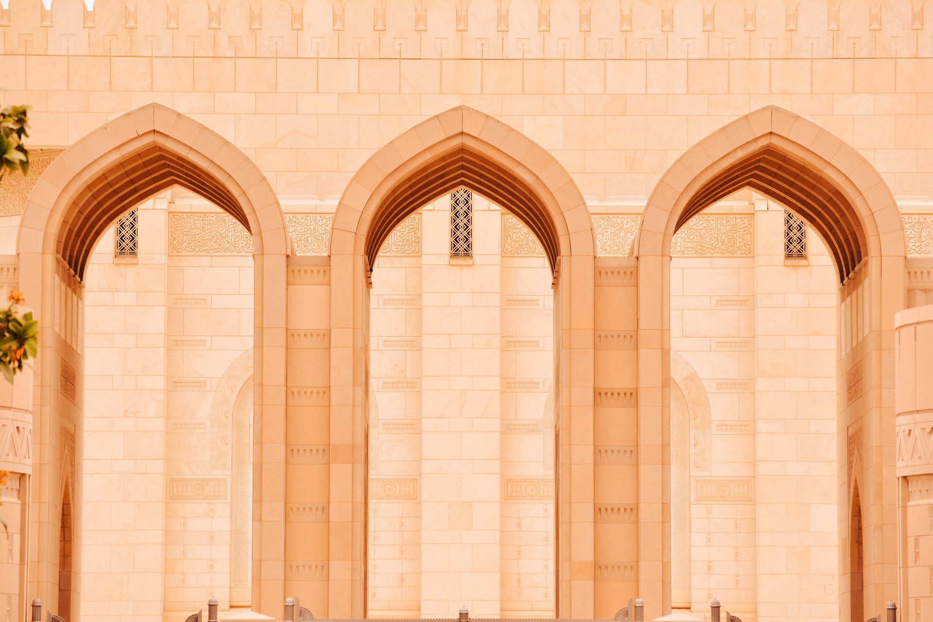 Close-up of elegant arches at the Sultan Qaboos Grand Mosque in Muscat, Oman.