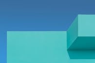 Minimalist turquoise building against clear sky