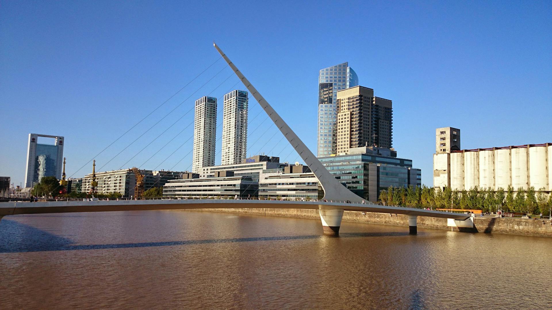 Stunning view of Puente de la Mujer and modern Buenos Aires skyline.