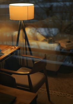 A warm and inviting interior setting with a lamp and wooden furniture in Istanbul.