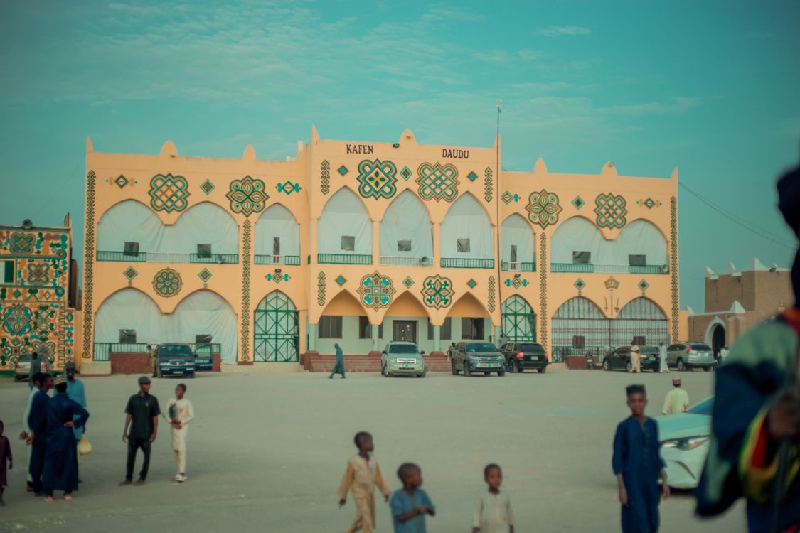 Community Building Patterns Colorful building with traditional patterns and people · Free Stock Photo