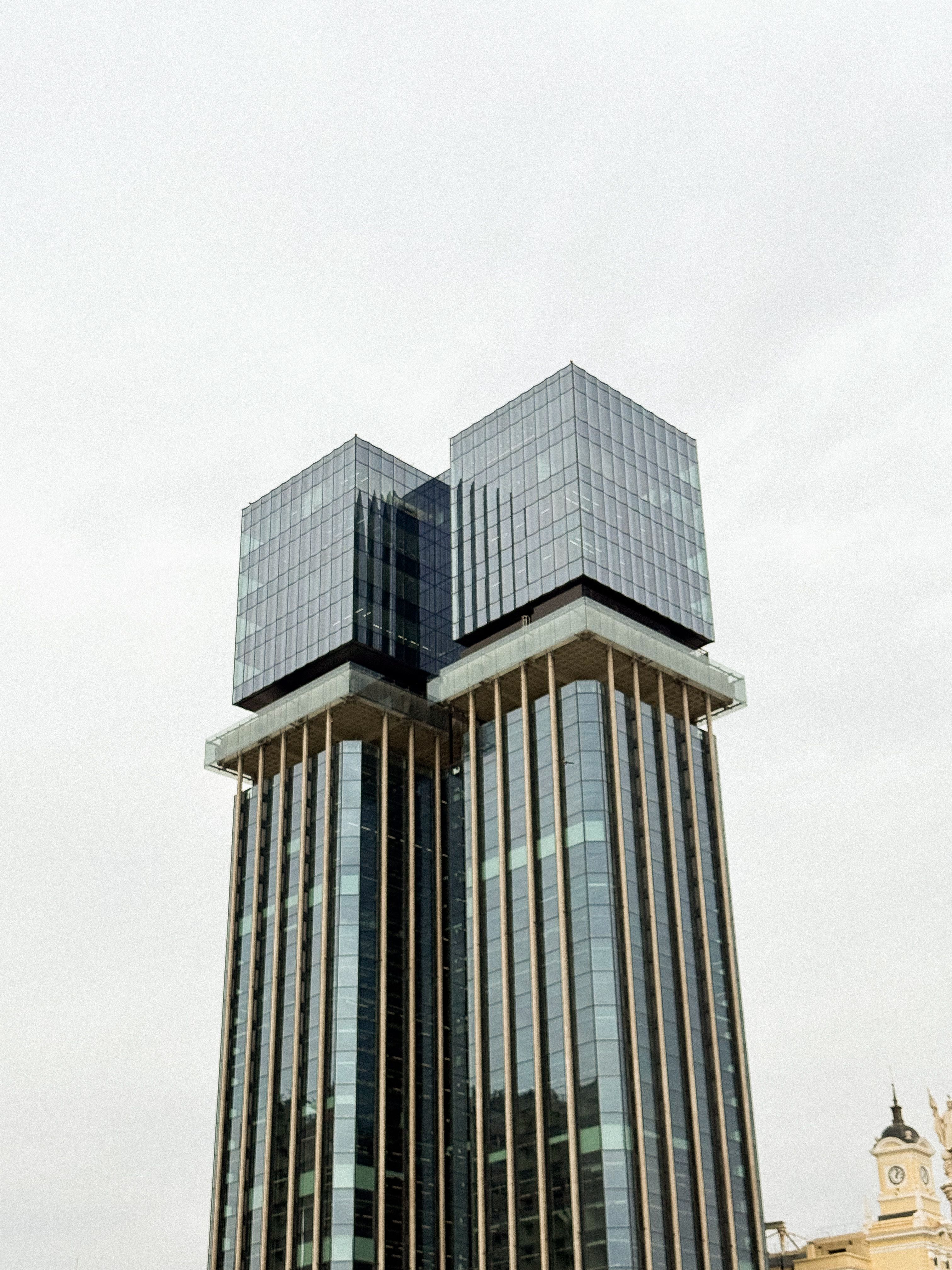 Modern Glass Skyscraper Towers Against Overcast Sky · Free Stock Photo