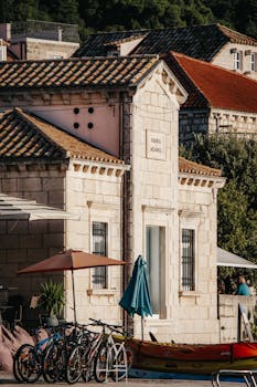 Explore the rustic charm of Croatian village architecture in Lopud, captured in warm summer light.