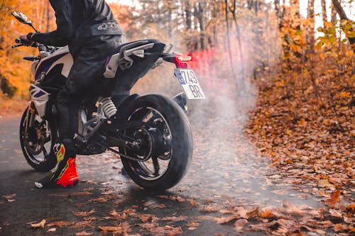 Man in Black Jacket Burning Out A Motorcycle