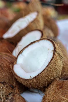 Sliced open coconuts with fresh white meat visible, perfect for tropical themes.