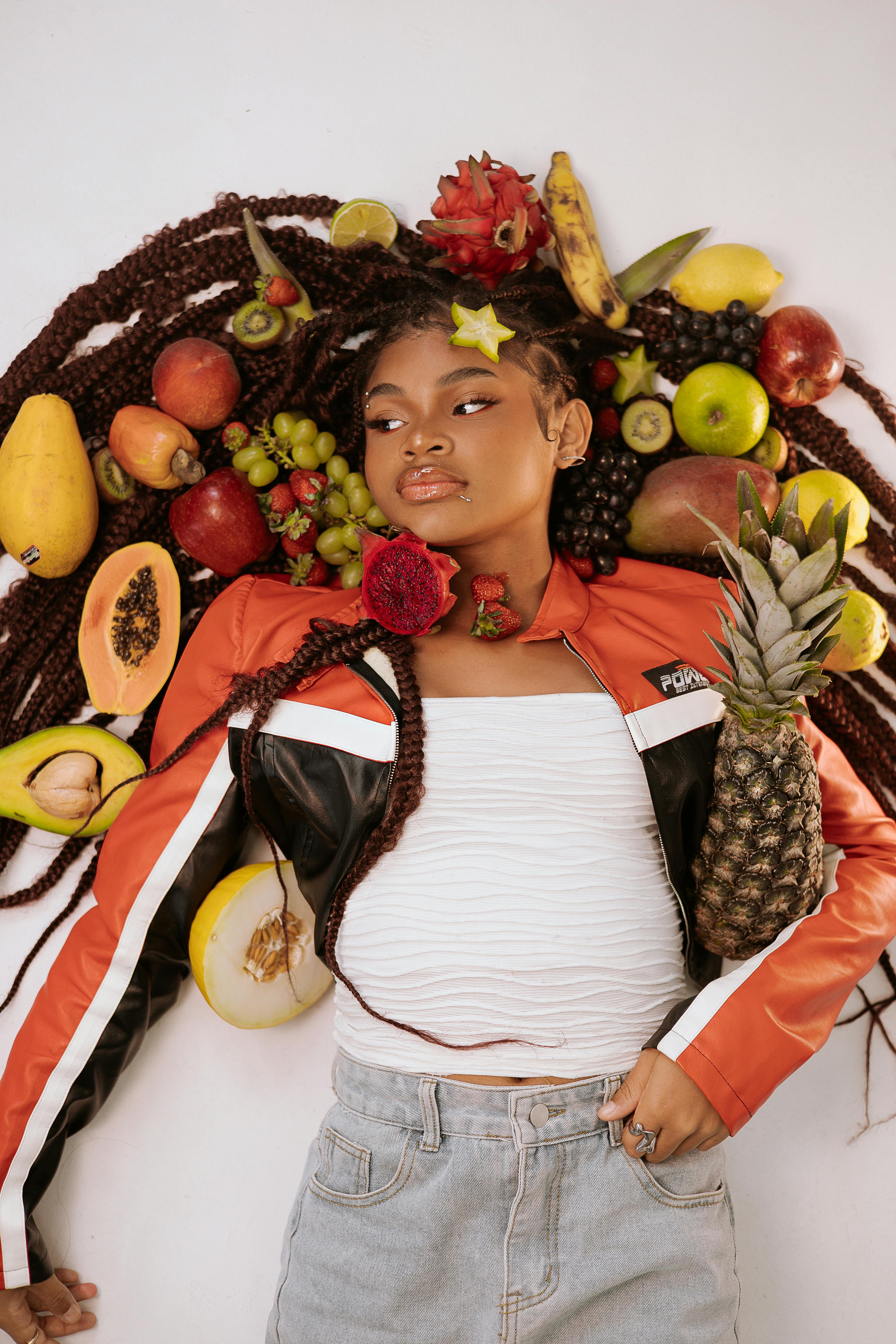 Woman Posing With Assorted Tropical Fruits · Free Stock Photo