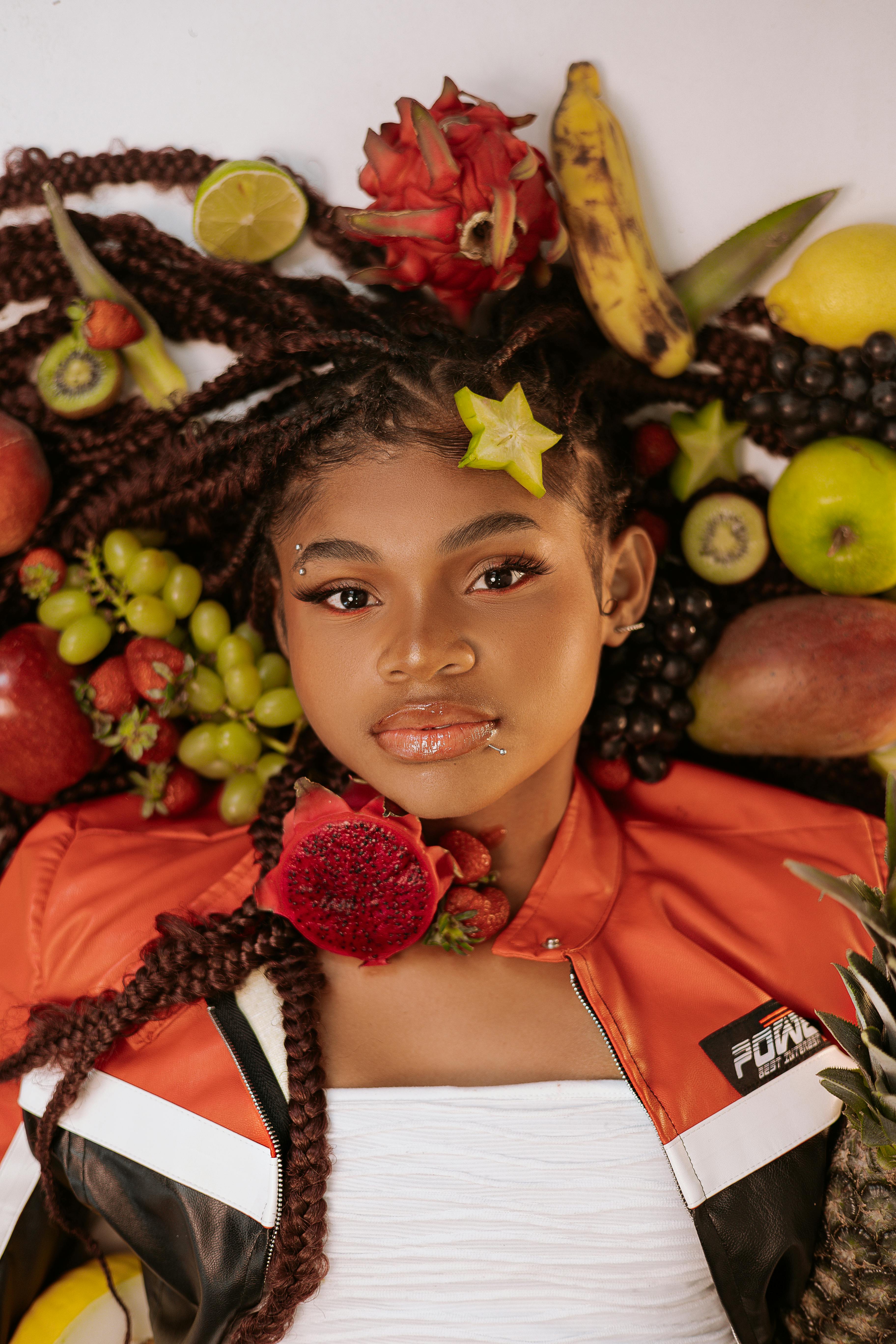 Woman Posing With Assorted Tropical Fruits · Free Stock Photo