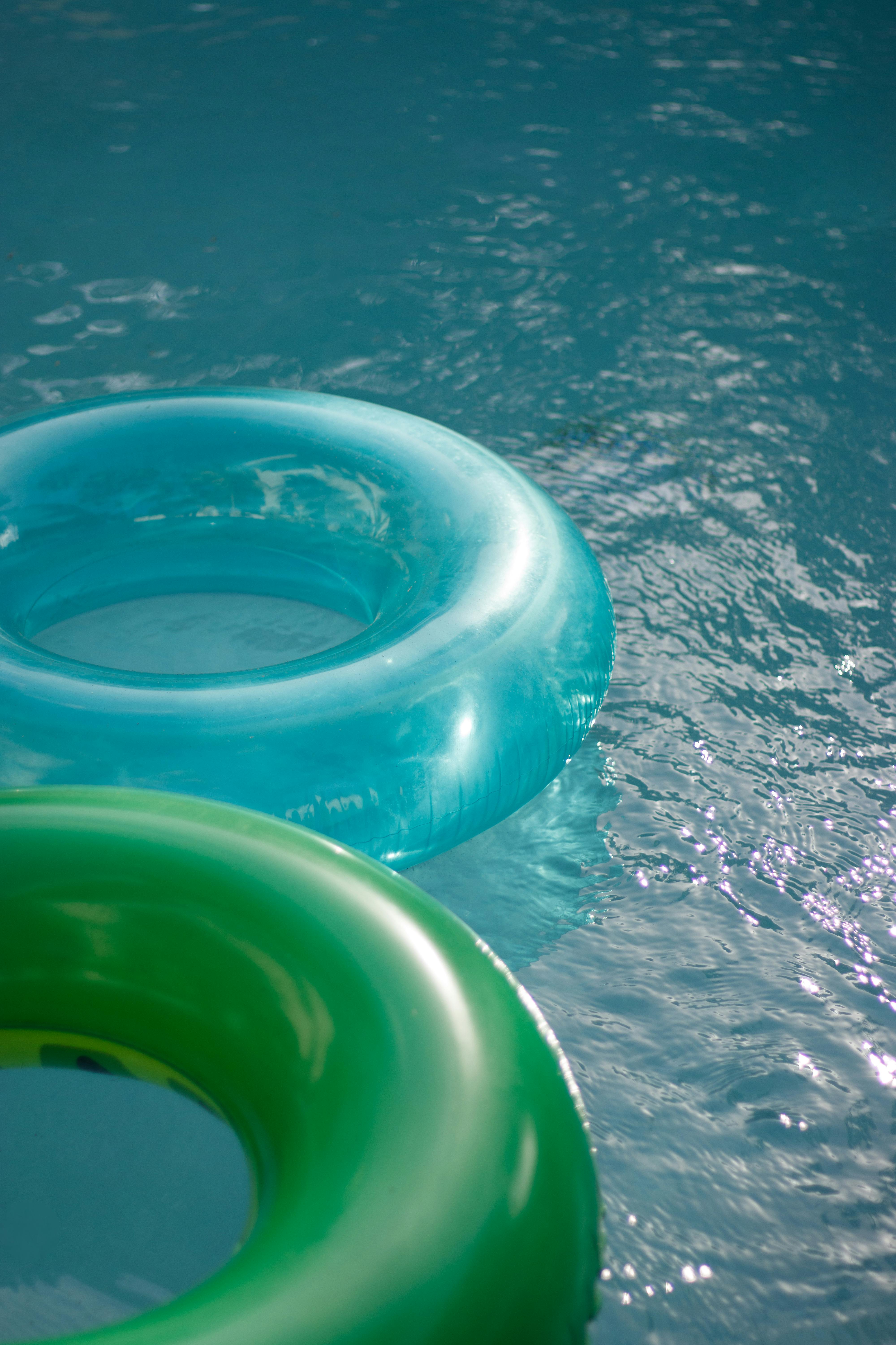 refreshing blue and green pool floats in water