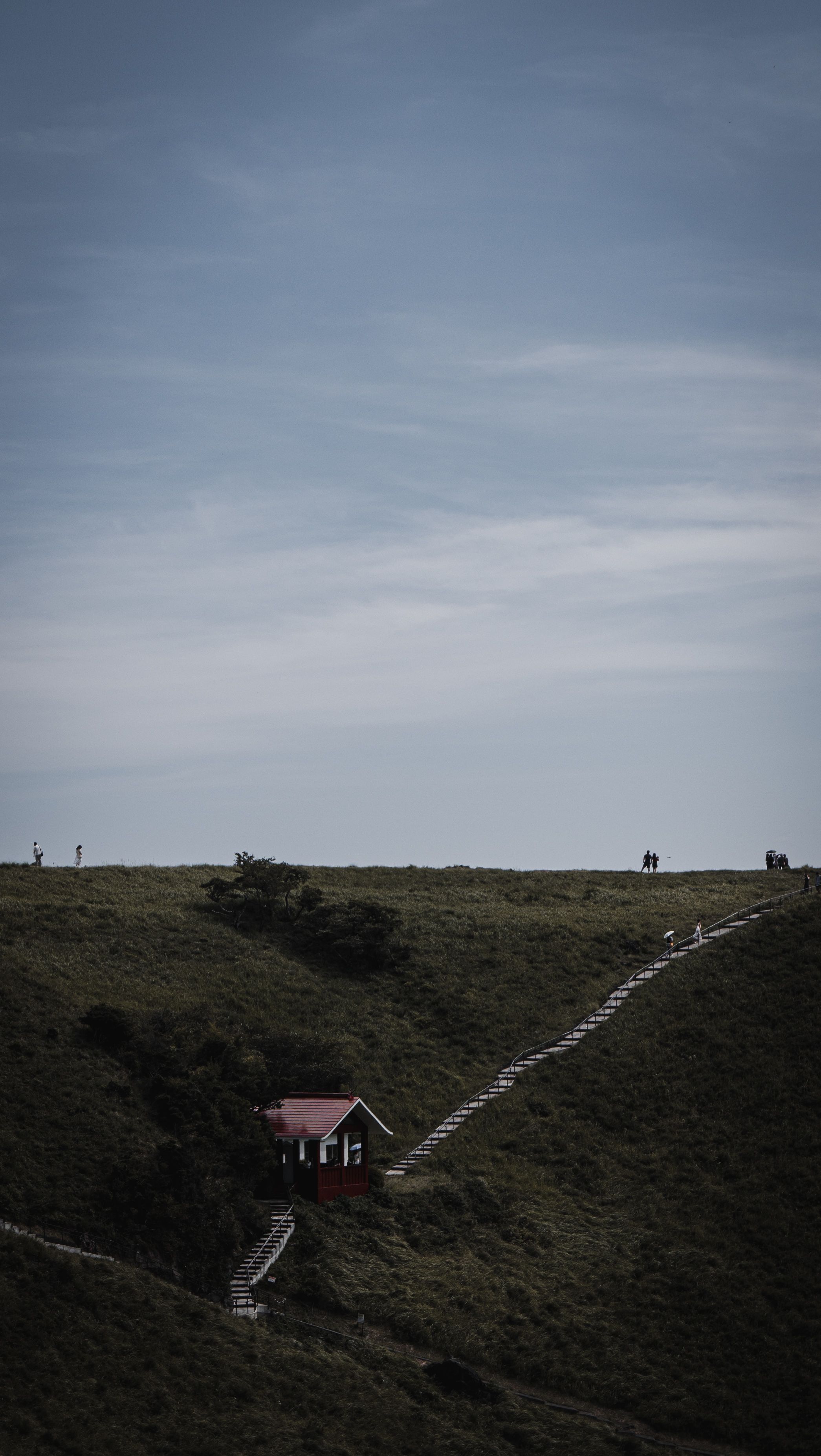 Serene Hillside with Cabin and Pathway · Free Stock Photo