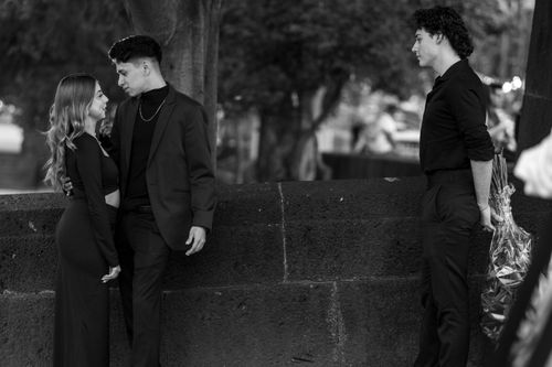 Free A dramatic black and white scene depicting a love triangle in an urban park setting. Stock Photo