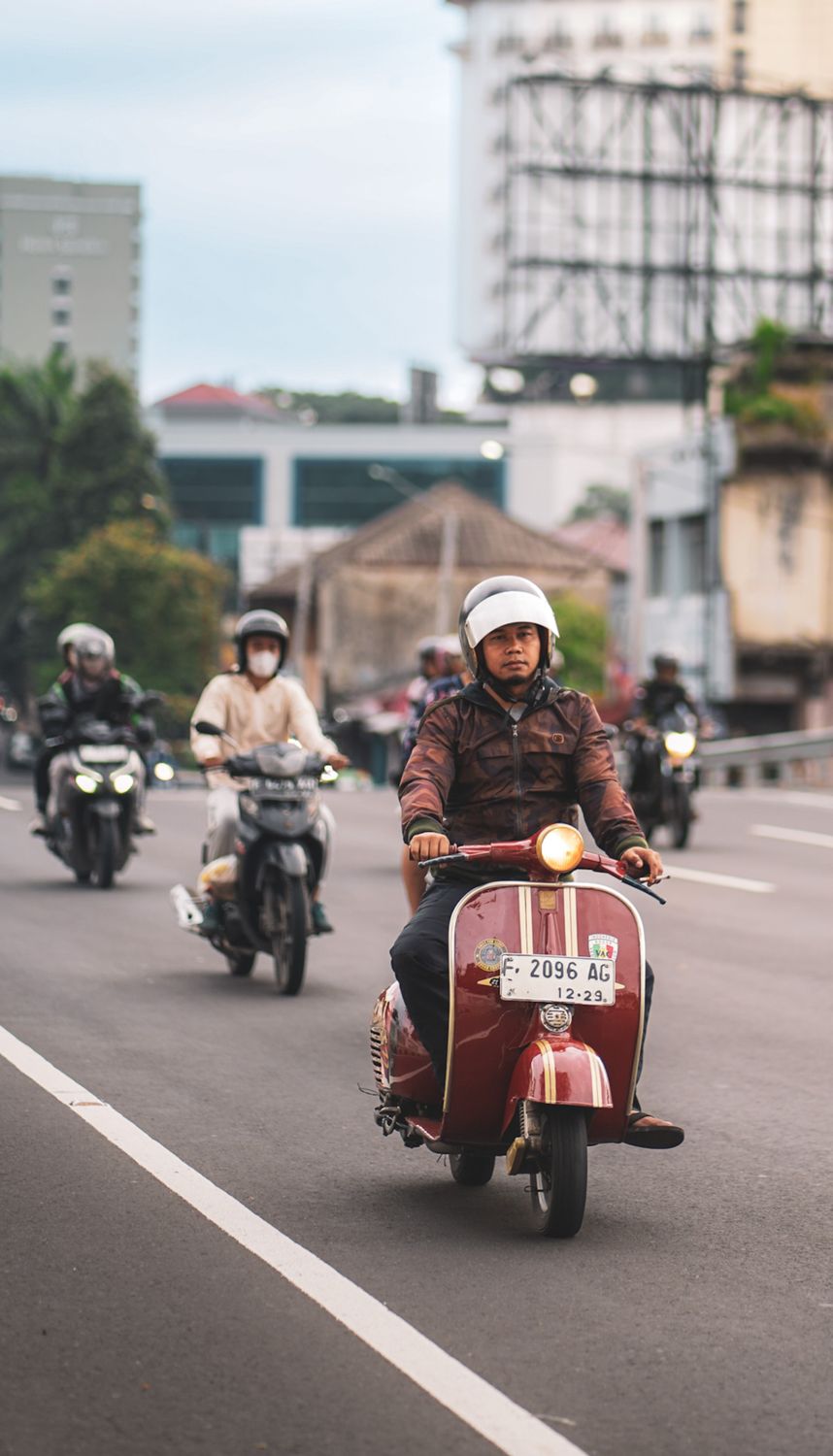 Java Street Rider Classic Vespa Riding in Urban West Java Street · Free Stock Photo