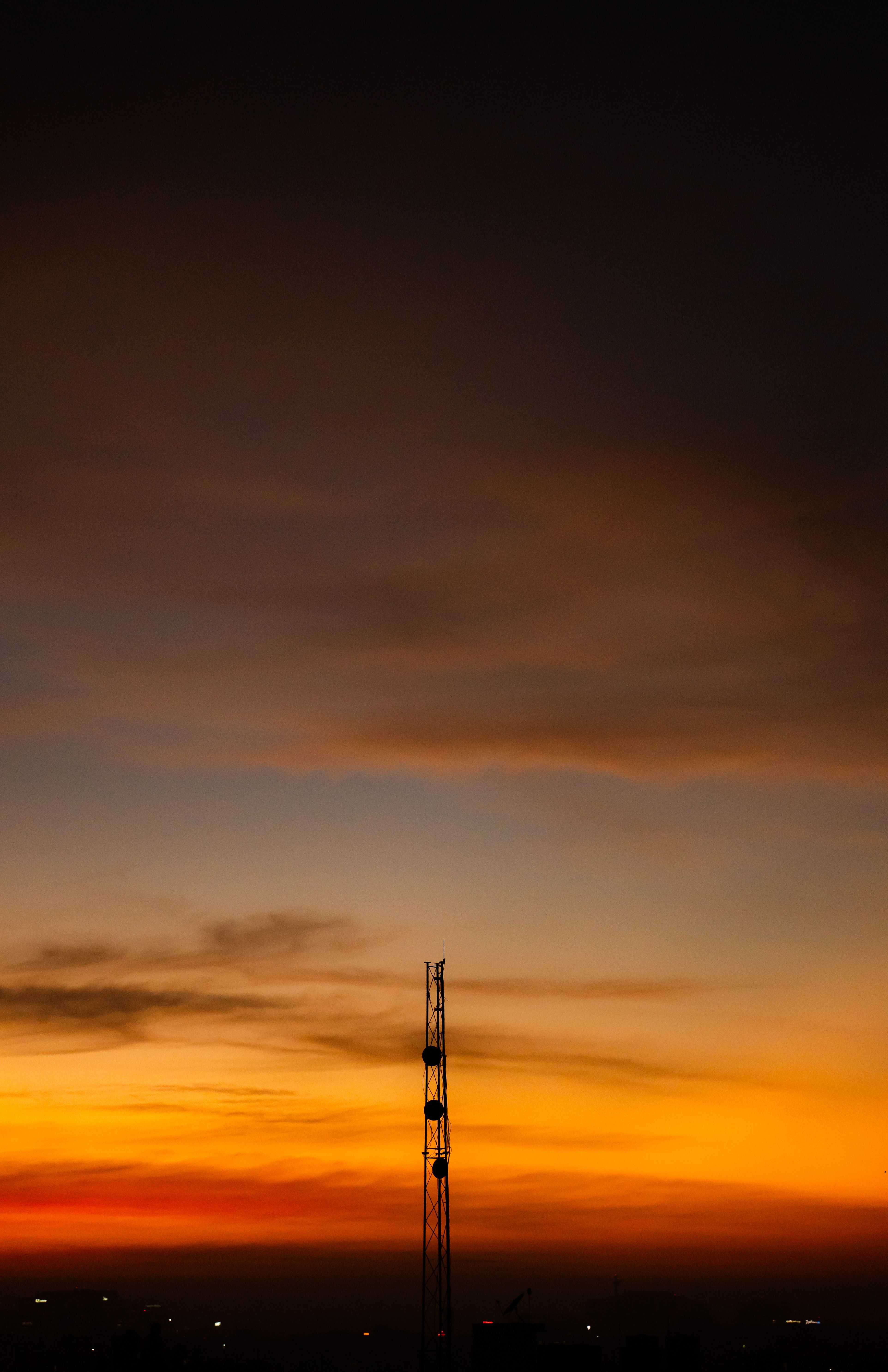 A striking silhouette of a tower during a vibrant sunset in Bengaluru, India.