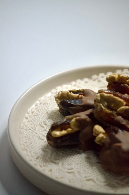 Free A plate of chocolate-covered dates filled with walnuts, perfect for Ramadan and festive occasions. Stock Photo