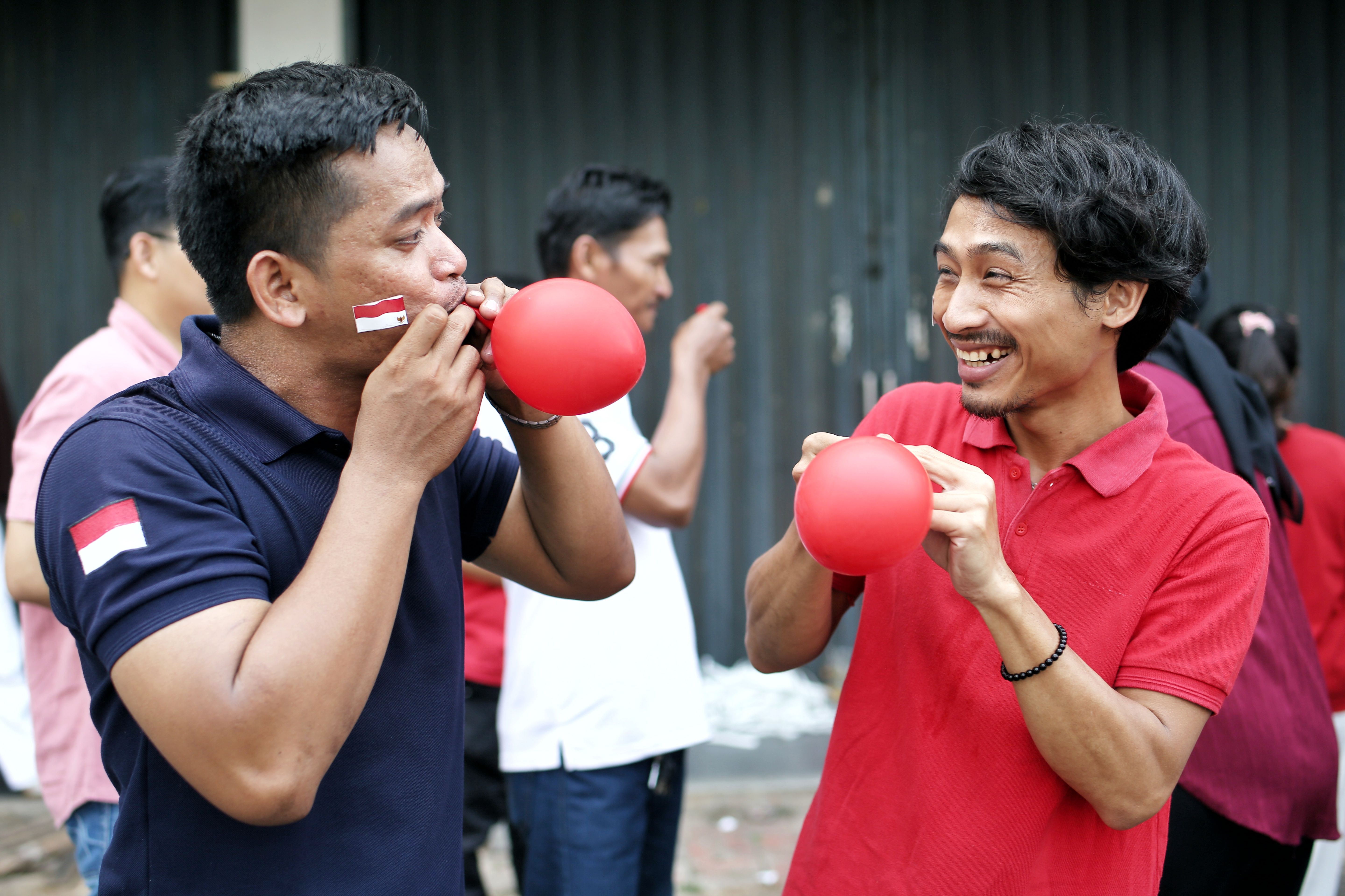 Two men enjoying a festive event in Jakarta, Indonesia.