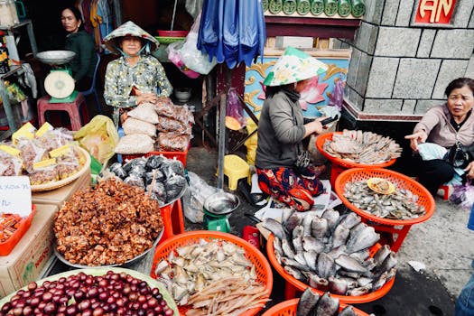 Lively Vietnamese street market with seafood and produce stalls.
