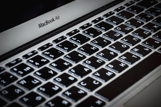 Detailed close-up of a MacBook Air keyboard featuring Cyrillic characters, capturing sleek technology.