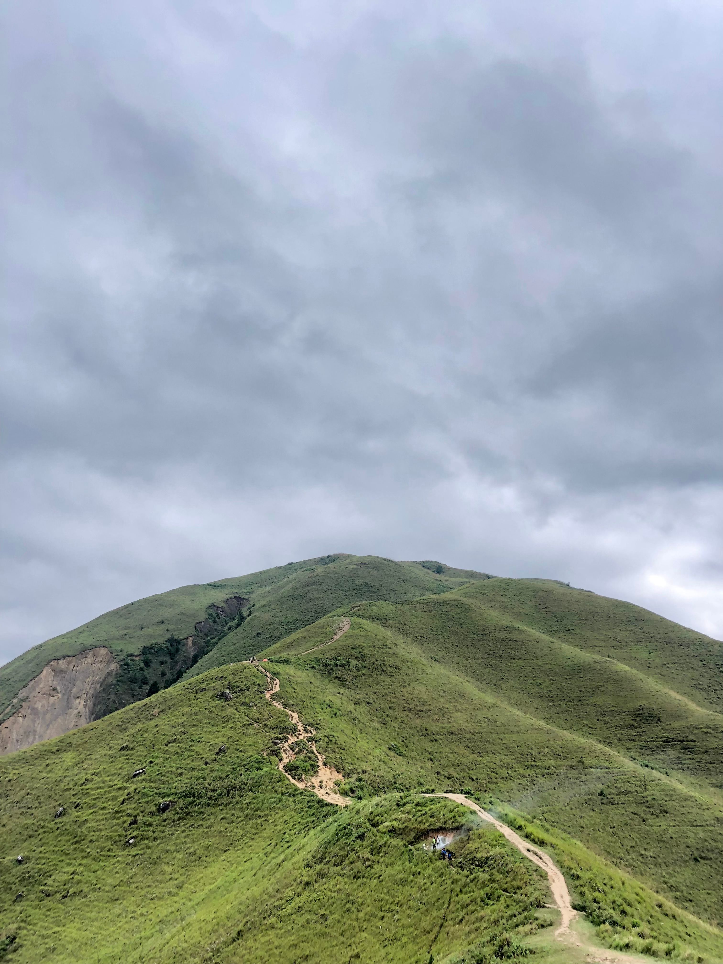 Lush Green Mountain Under Cloudy Sky · Free Stock Photo