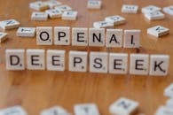 Scrabble Tiles Spelling OpenAI and DeepSeek