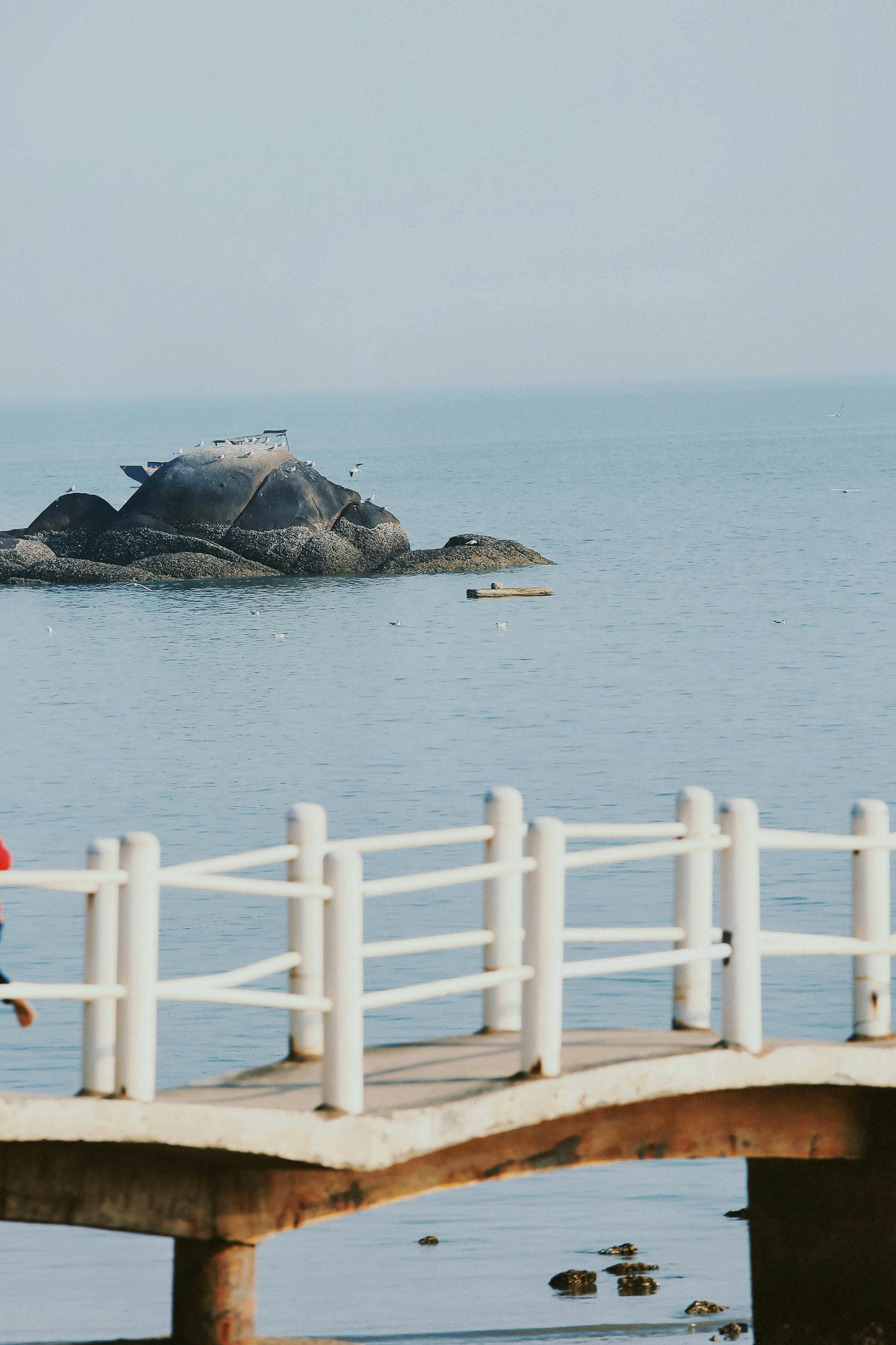 tranquil pier overlooking rocky coastal waters