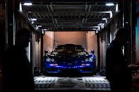 Sleek Supercar in Transport Container at Night