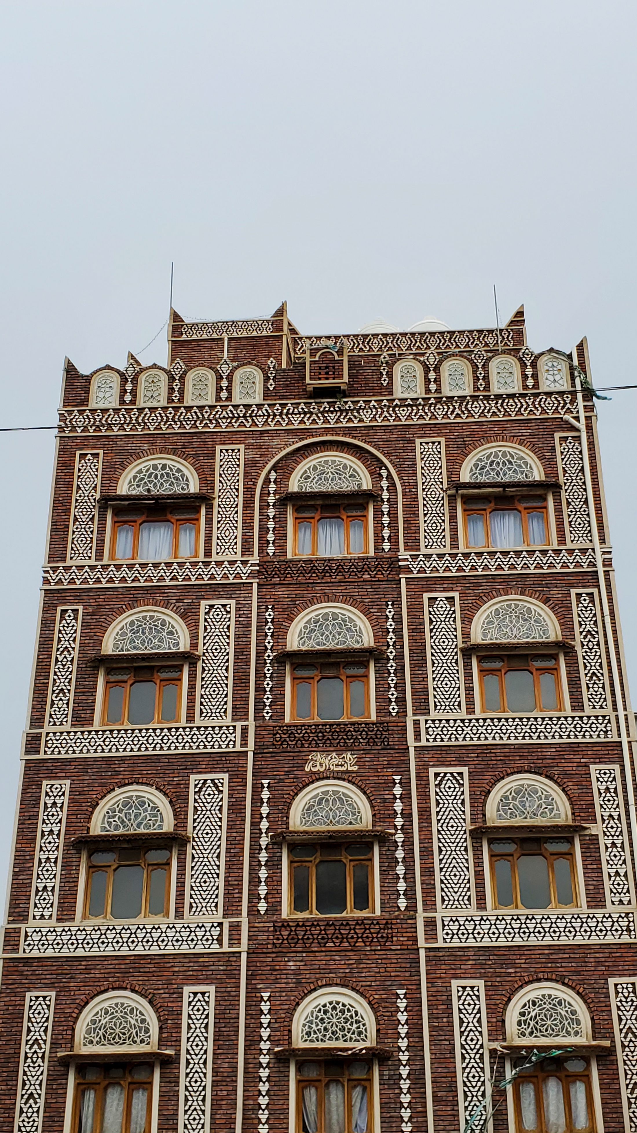 Intricate traditional architecture of a multi-story building in Sana'a, Yemen.